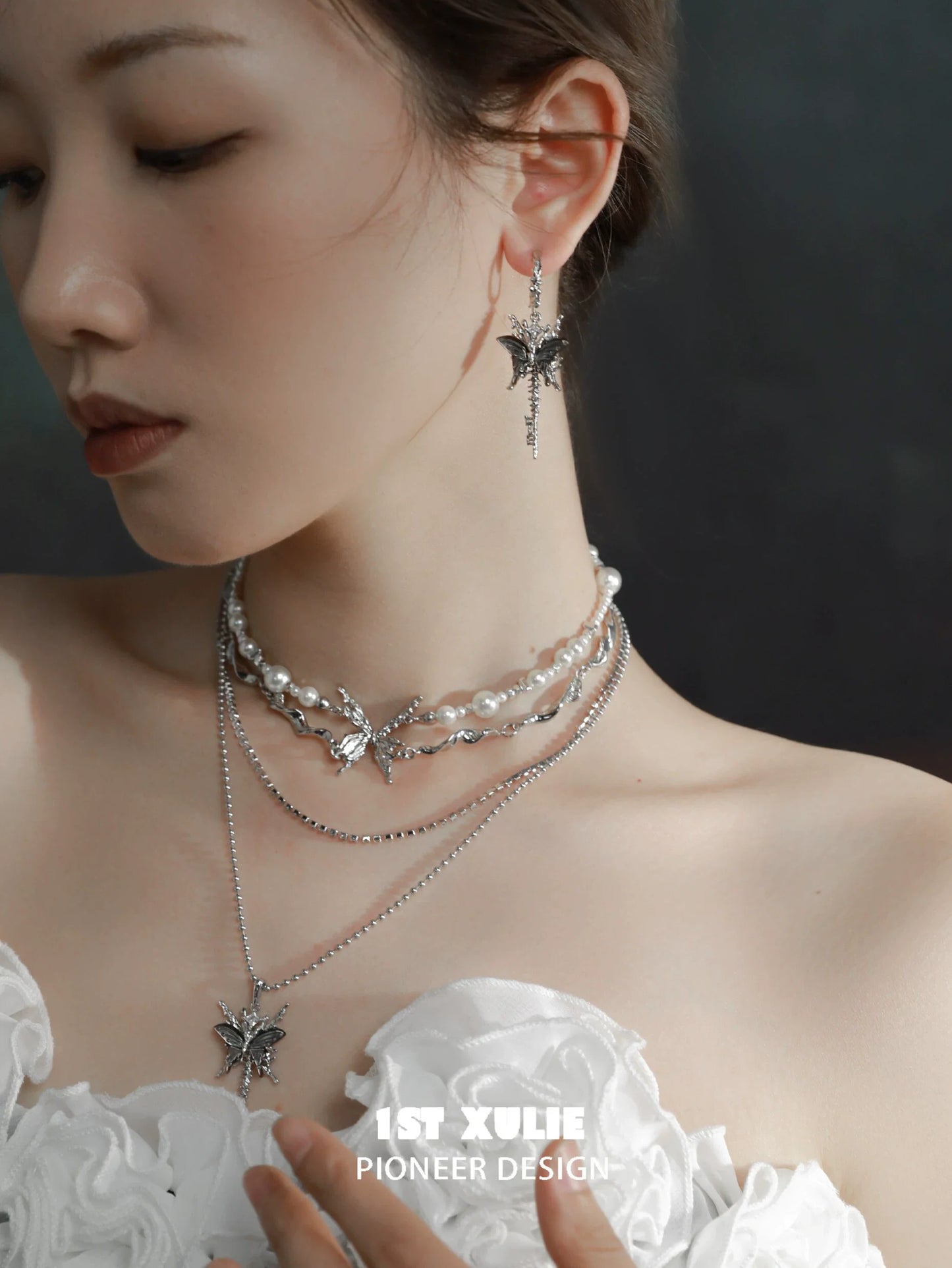 Stunning skeleton butterfly pearl necklace paired with matching earrings for an elegant look