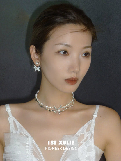 Elegant skeleton butterfly pearl necklace by 1STXULIE, adorned with shimmering pearls and butterfly accents