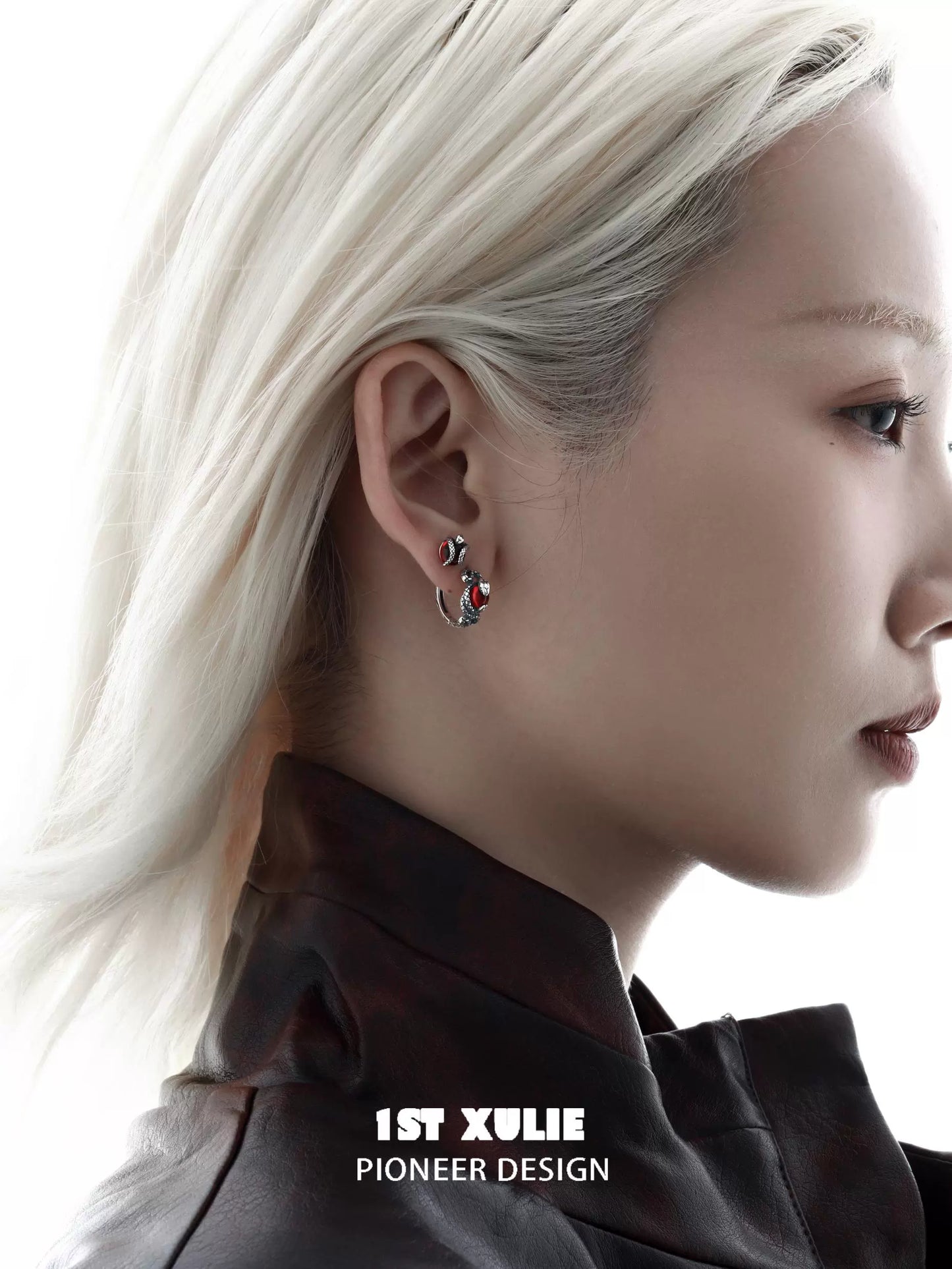 Stylish Slytherin fang earrings showcased on model with short blonde hair and dark jacket
