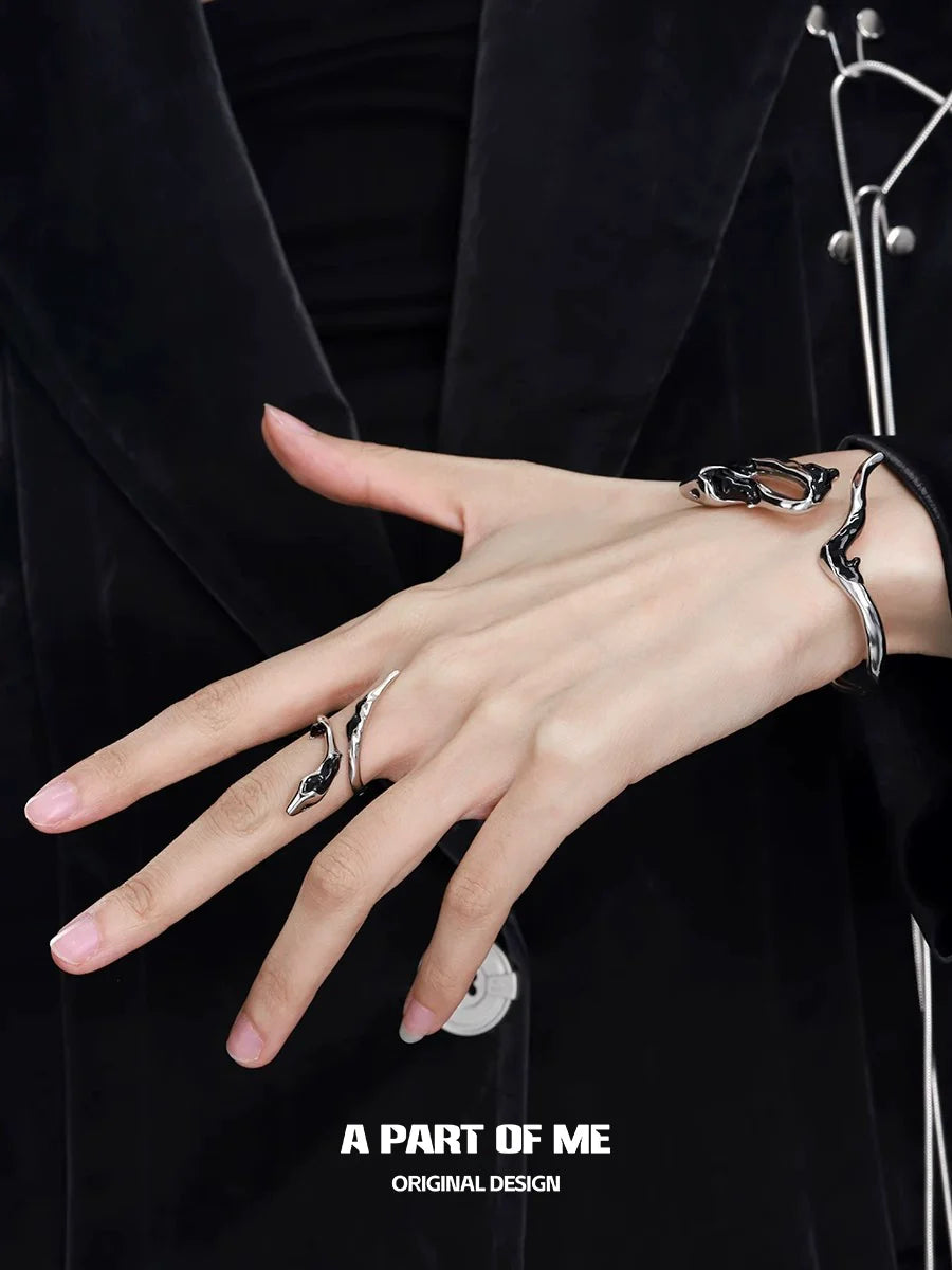 Slytherin inspired snake ring displayed on a model's hand with stylish black attire