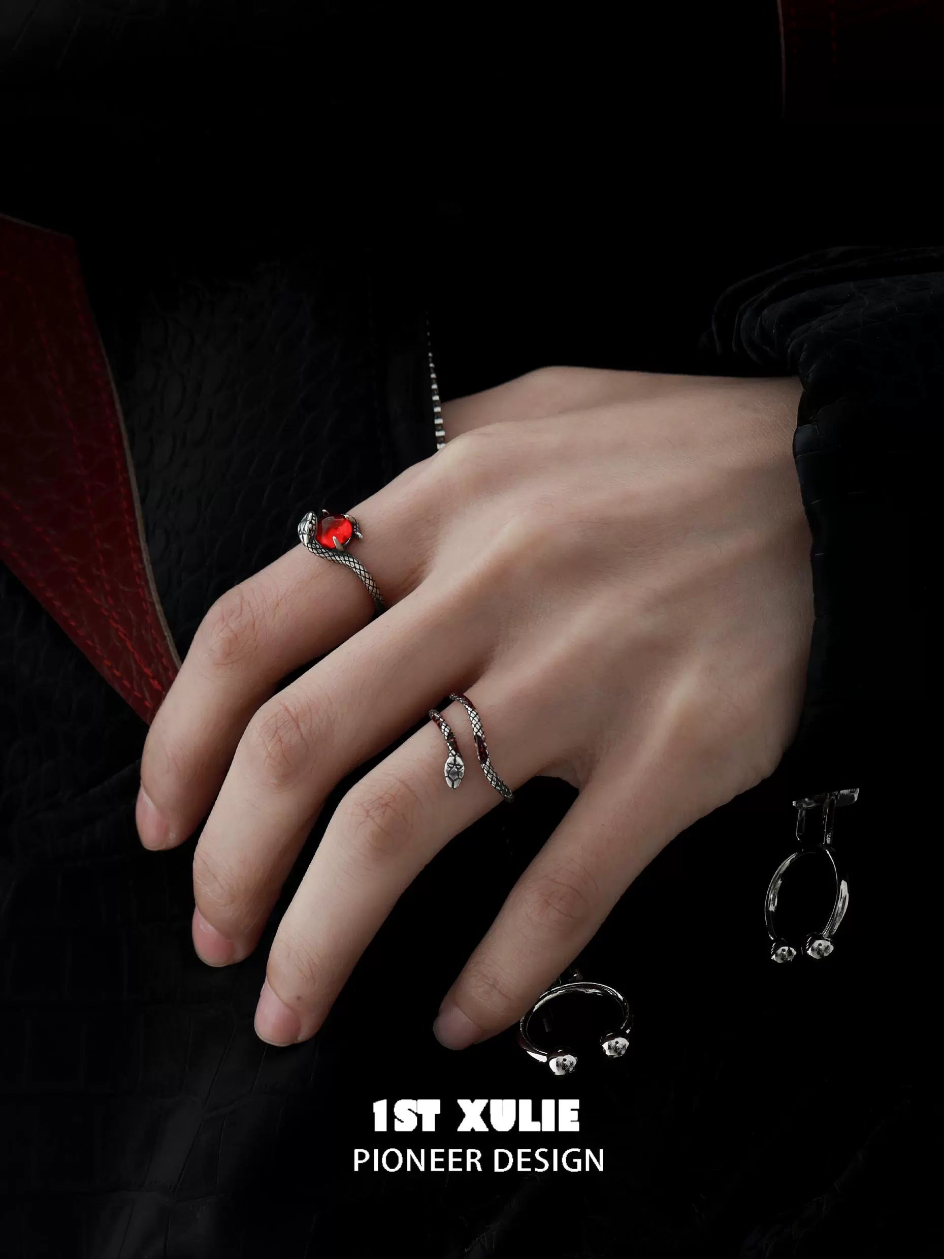 Slytherin snake couple rings with intricate design and red gemstones displayed on a hand