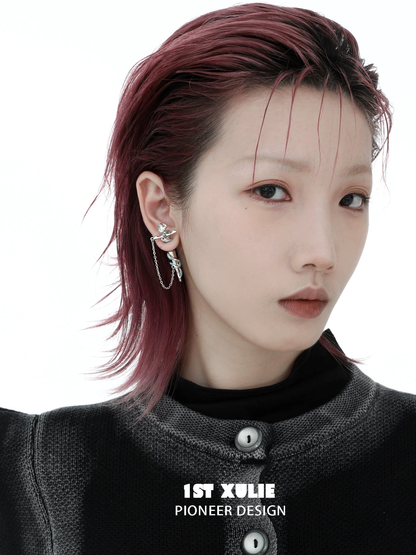 Stylish model wearing 1STXULIE snake chain piercing earrings with a modern design