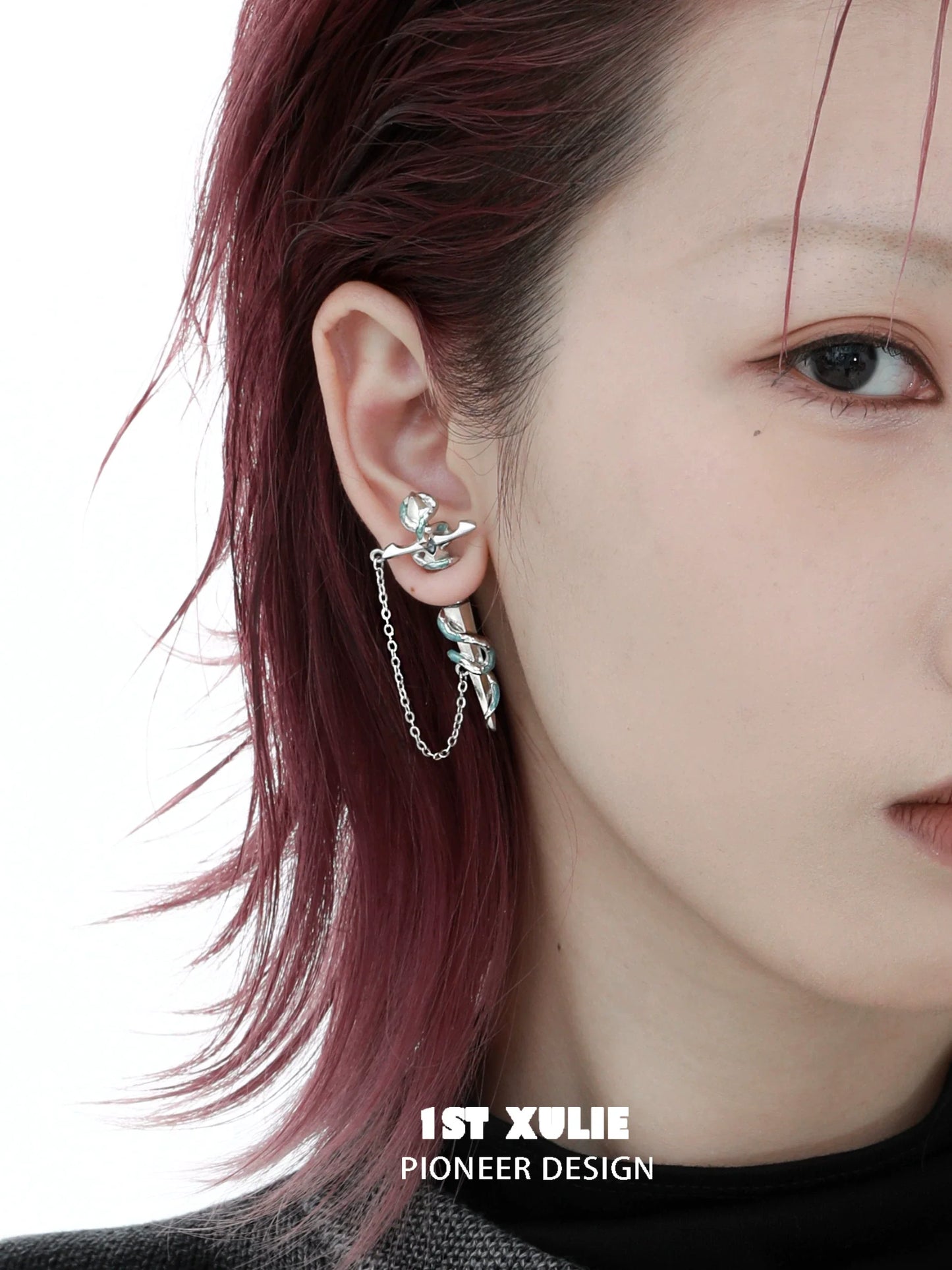 1ST XULIE snake chain piercing earrings in silver showcasing a unique and modern design