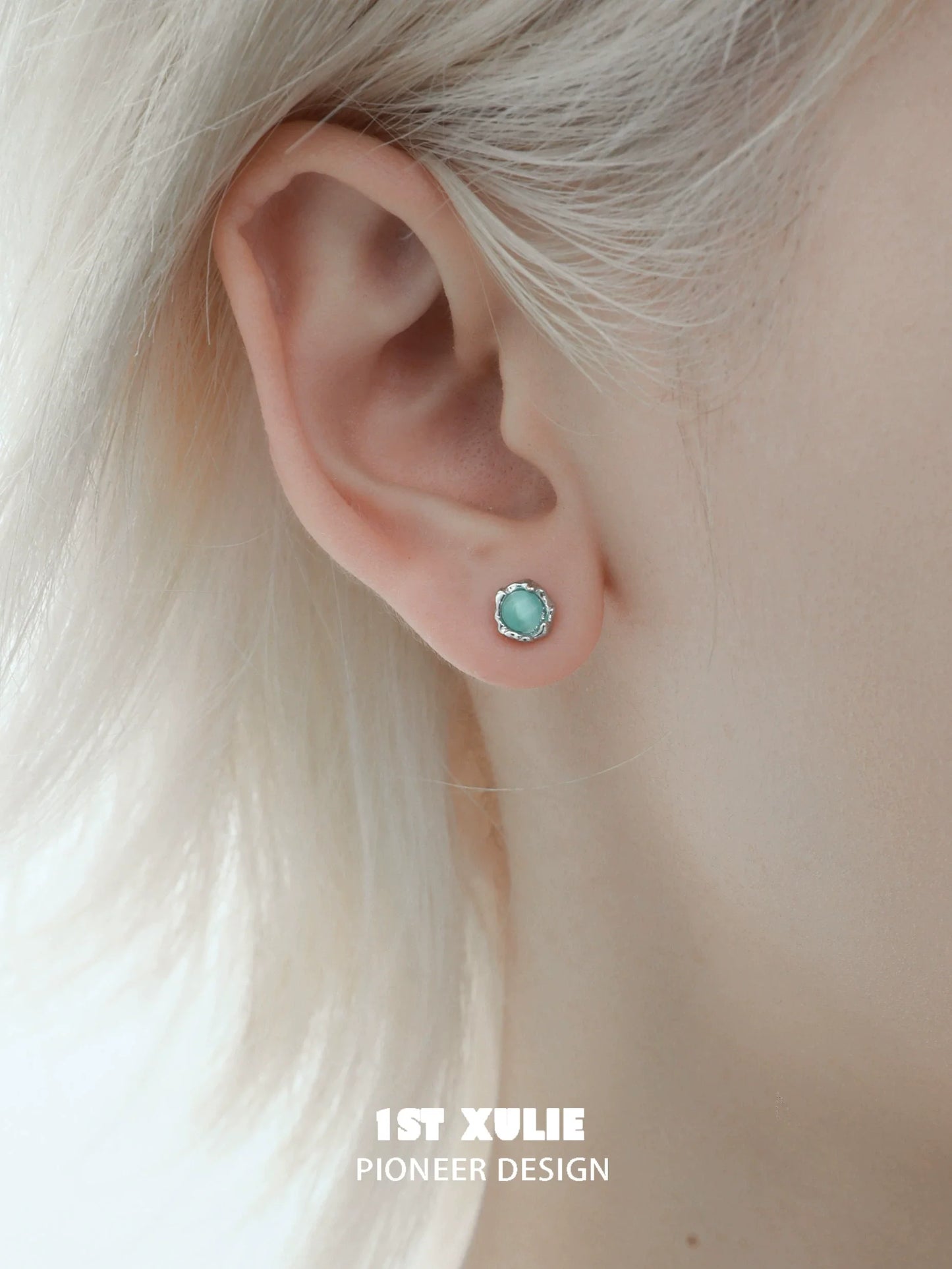 1ST XULIE Snowflake Butterfly Earrings with Mint Green Center and Silver Accents on a Model's Ear