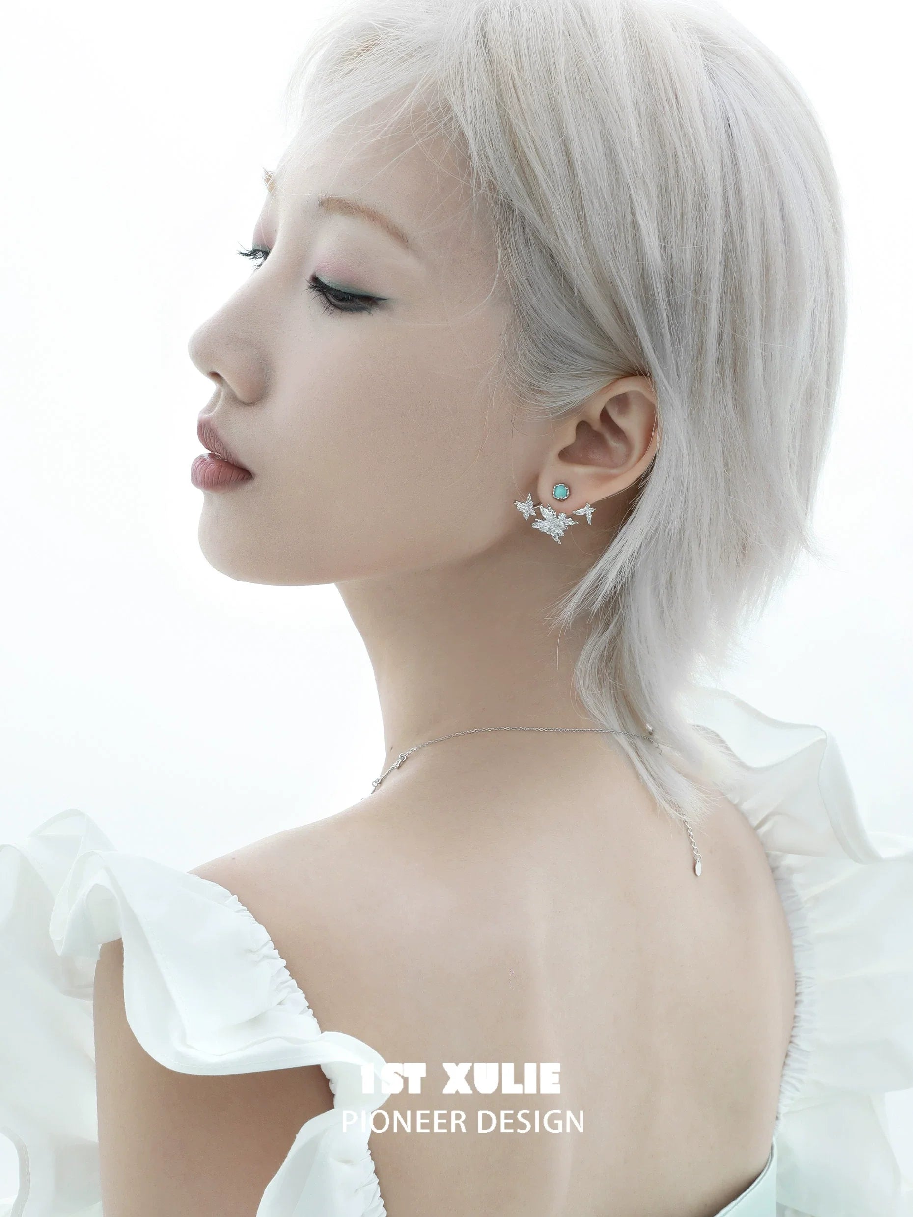 Elegant snowflake butterfly earrings showcased on a model with short hair and a delicate outfit