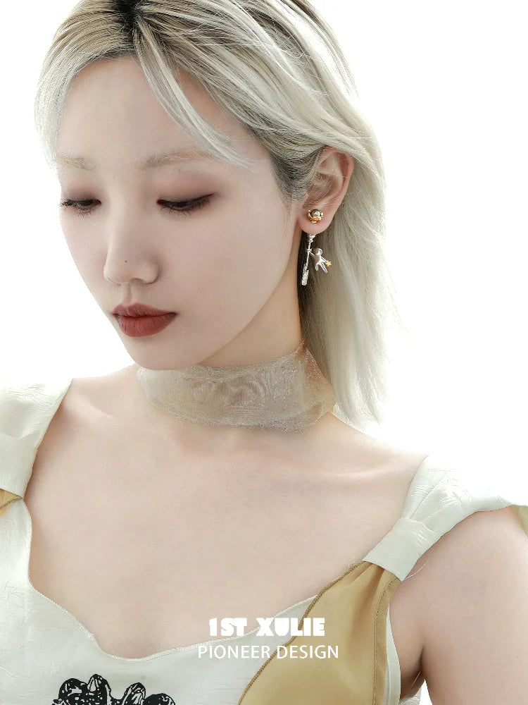 Elegant star stud earrings from 1ST XULIE worn by a model with a chic outfit