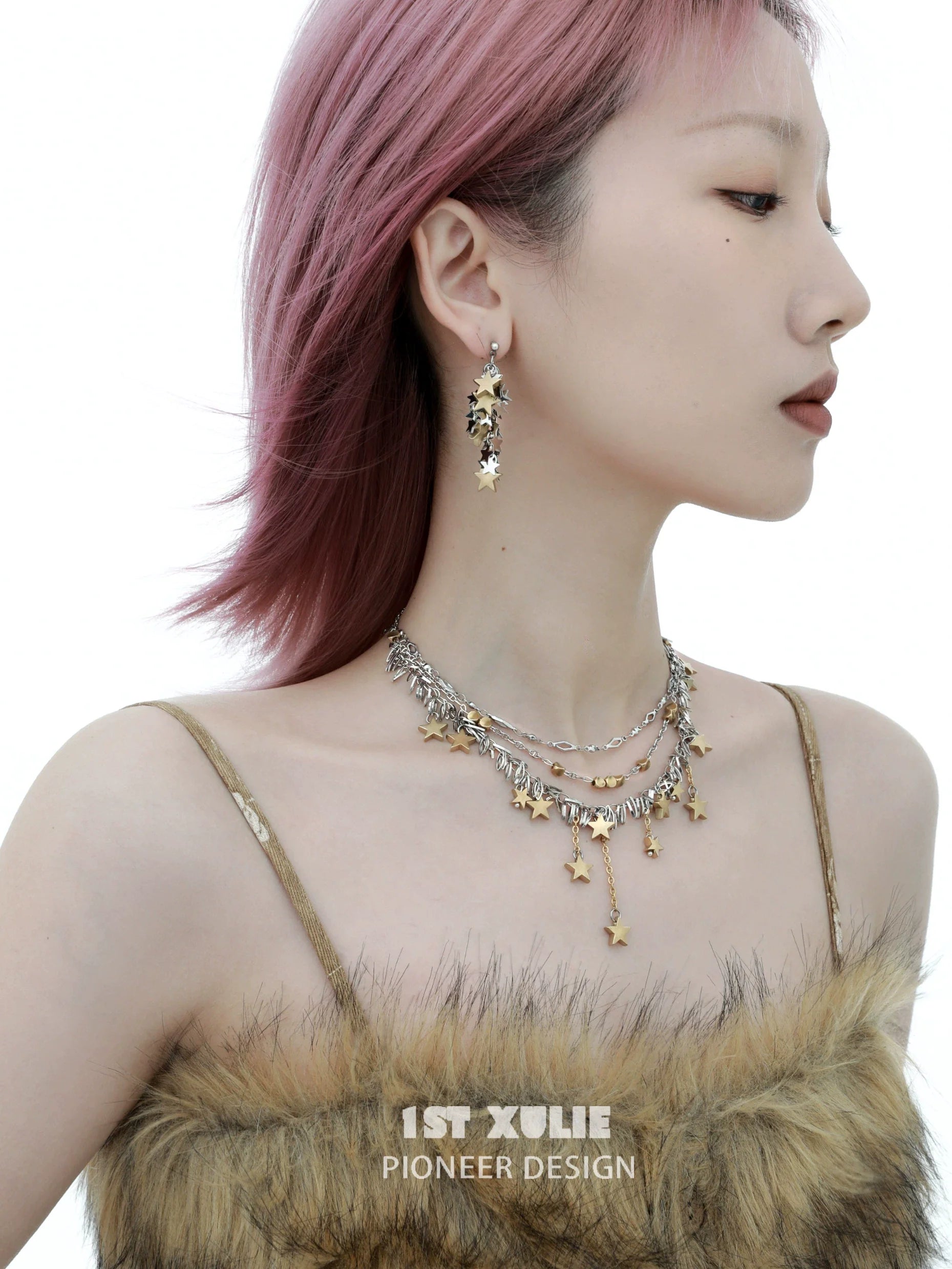 Model wearing star tassel earrings paired with layered silver necklaces for a trendy look