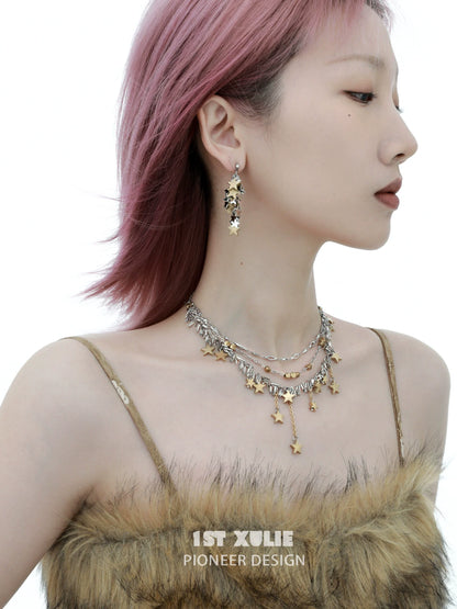 Model wearing star tassel earrings paired with layered silver necklaces for a trendy look
