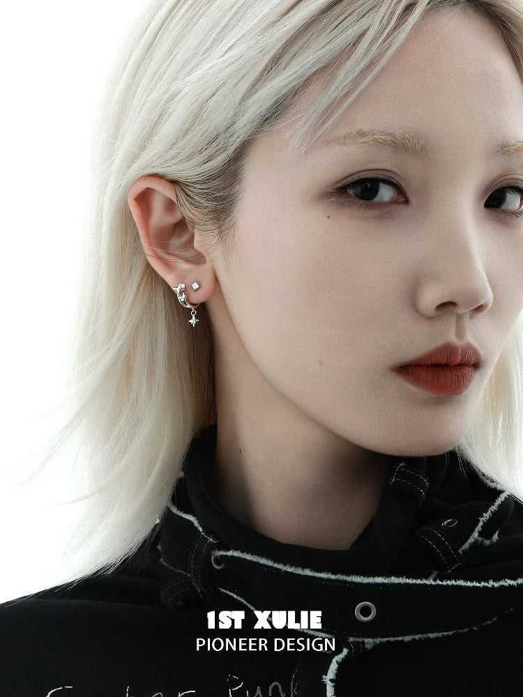 Model wearing star zircon earrings in silver, showcasing a stylish and contemporary jewelry design