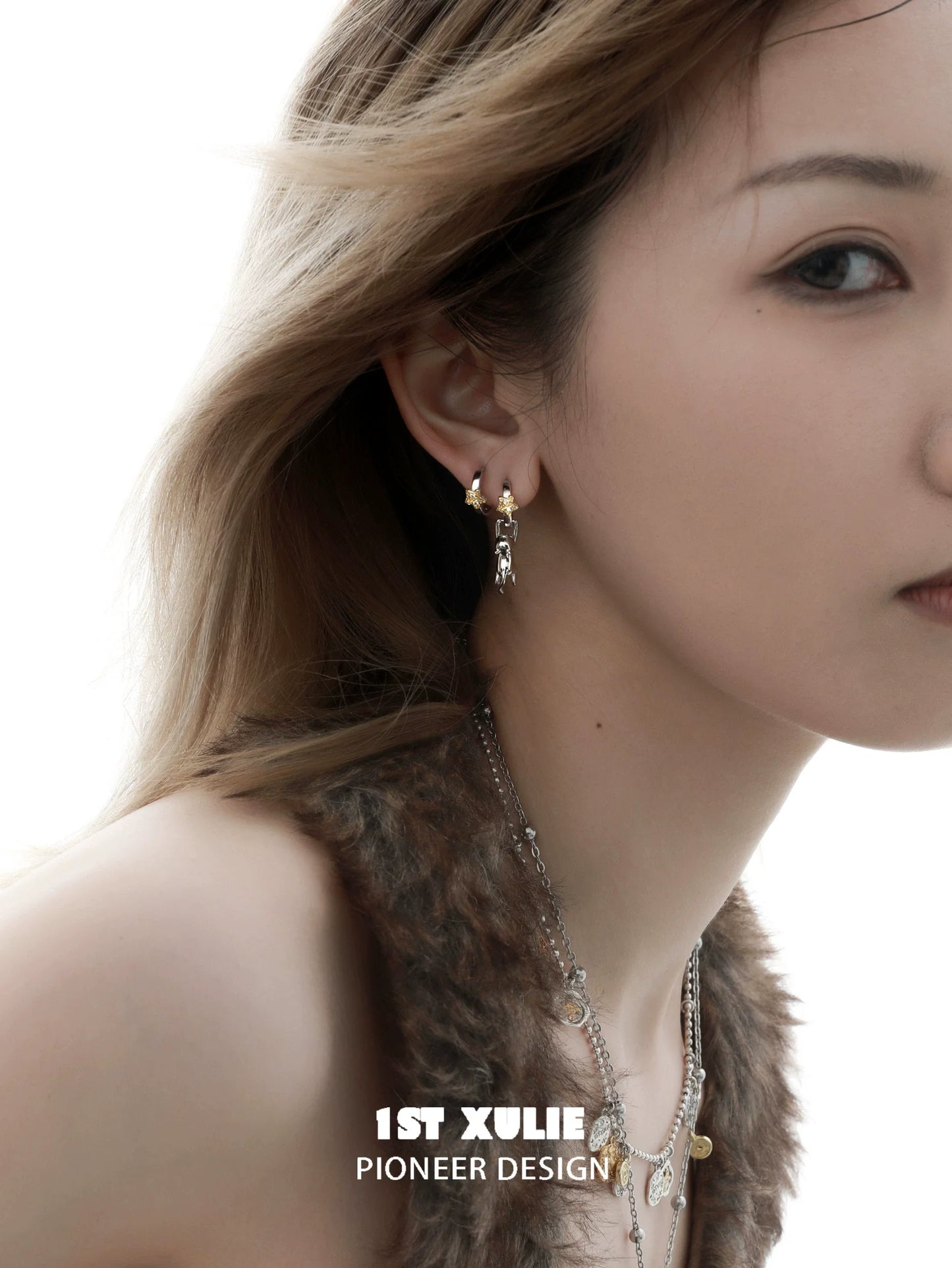 Elegant starlit cat silver earrings showcased on a model with flowing hair