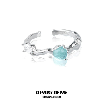 A PART OF ME silver statement ring featuring a blue gemstone centerpiece and sparkling accents