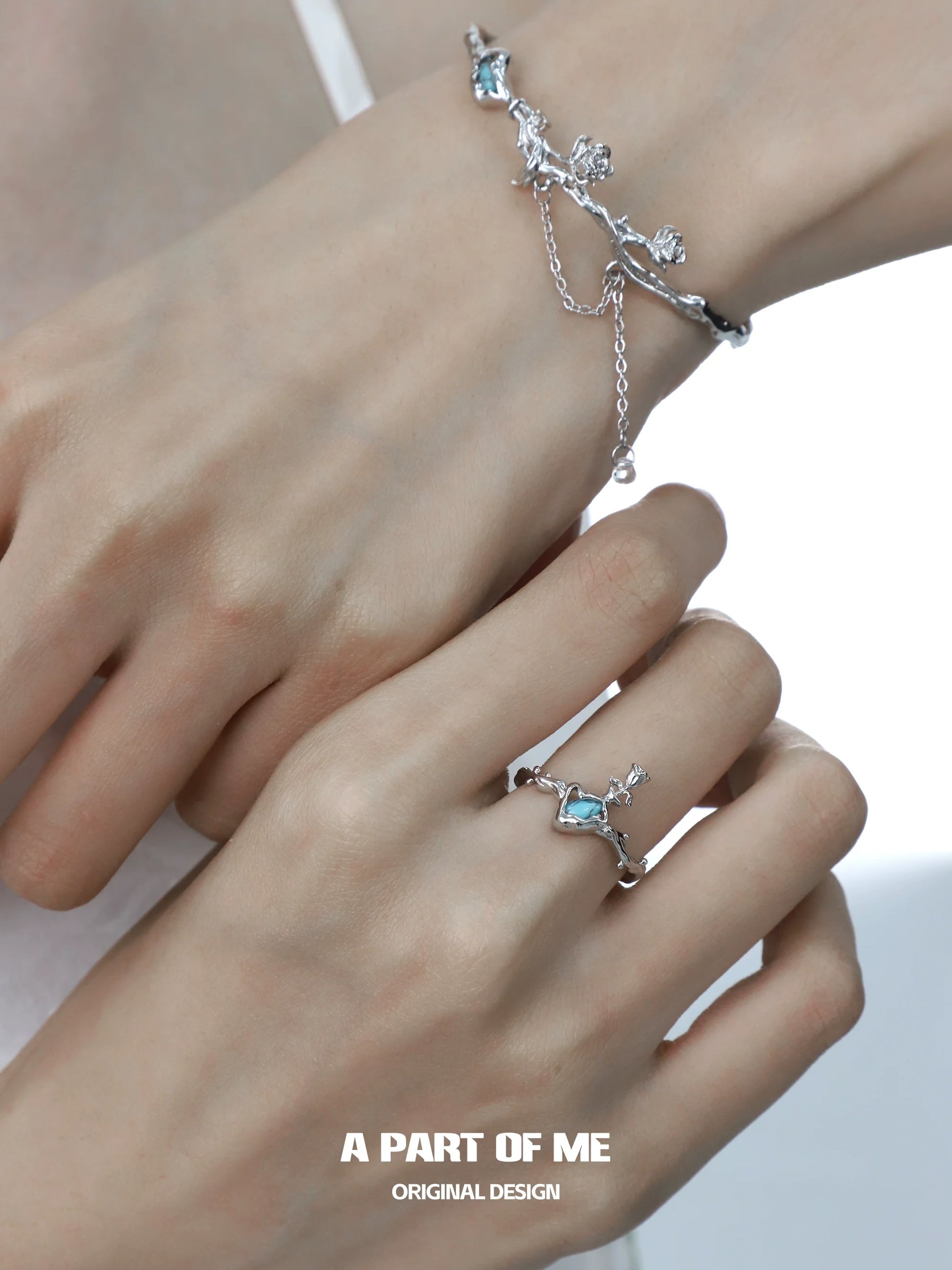A PART OF ME summer rose ring showcased on a hand with matching silver bracelet for a delicate look