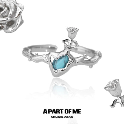 A PART OF ME summer rose ring featuring a delicate heart design with a turquoise stone