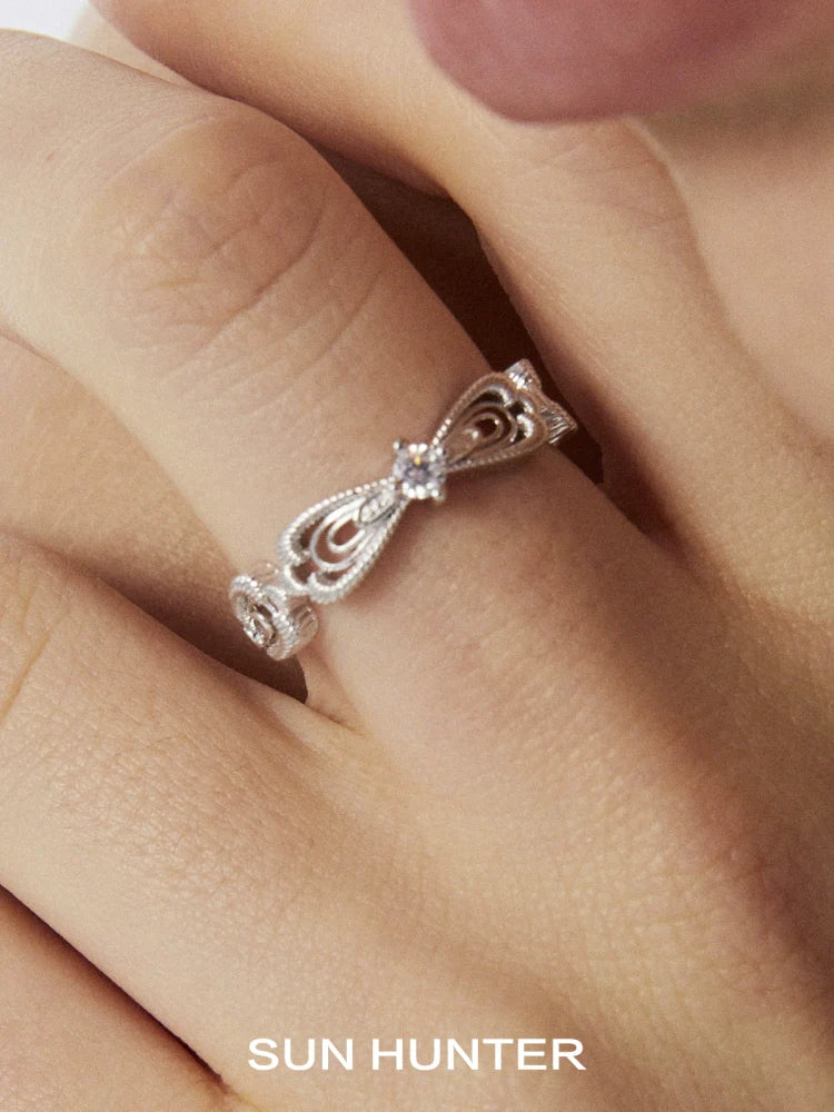 Silver SUN HUNTER bow lace ring featuring intricate lace designs and sparkling accents