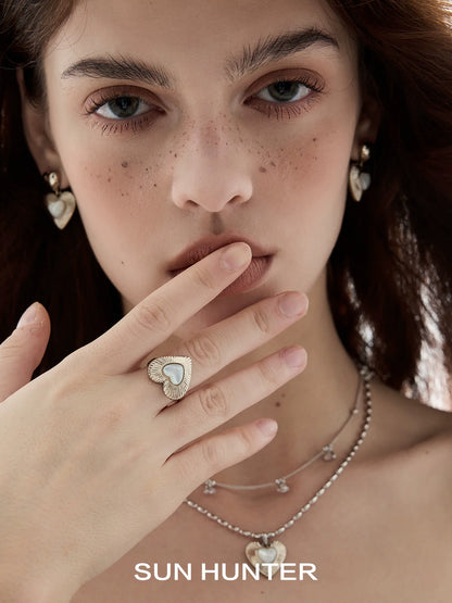 Elegant butterfly mother-of-pearl ring worn by model showcasing delicate jewelry pieces