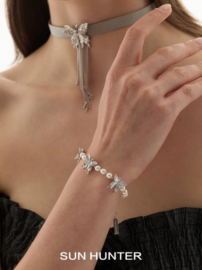 SUN HUNTER butterfly pearl bracelet featuring elegant butterfly accents and shimmering pearls