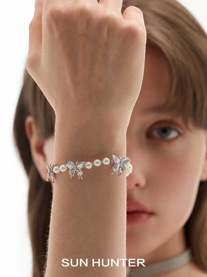 SUN HUNTER butterfly pearl bracelet featuring silver butterflies and elegant pearls for a stylish look
