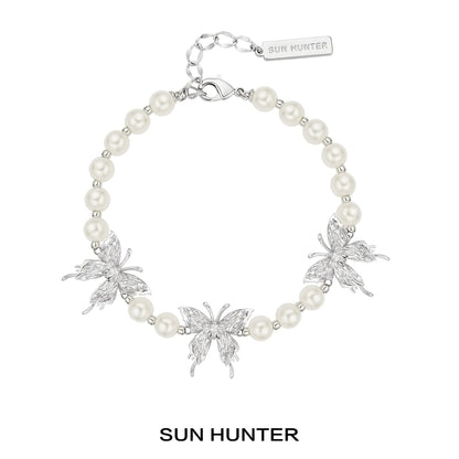 SUN HUNTER butterfly pearl bracelet featuring silver butterflies and elegant pearls
