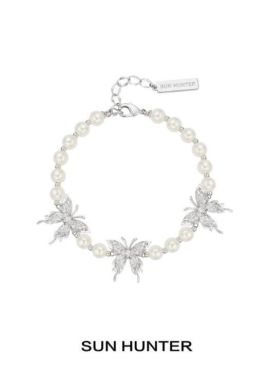 SUN HUNTER butterfly pearl bracelet with silver butterfly charms and elegant pearl beads