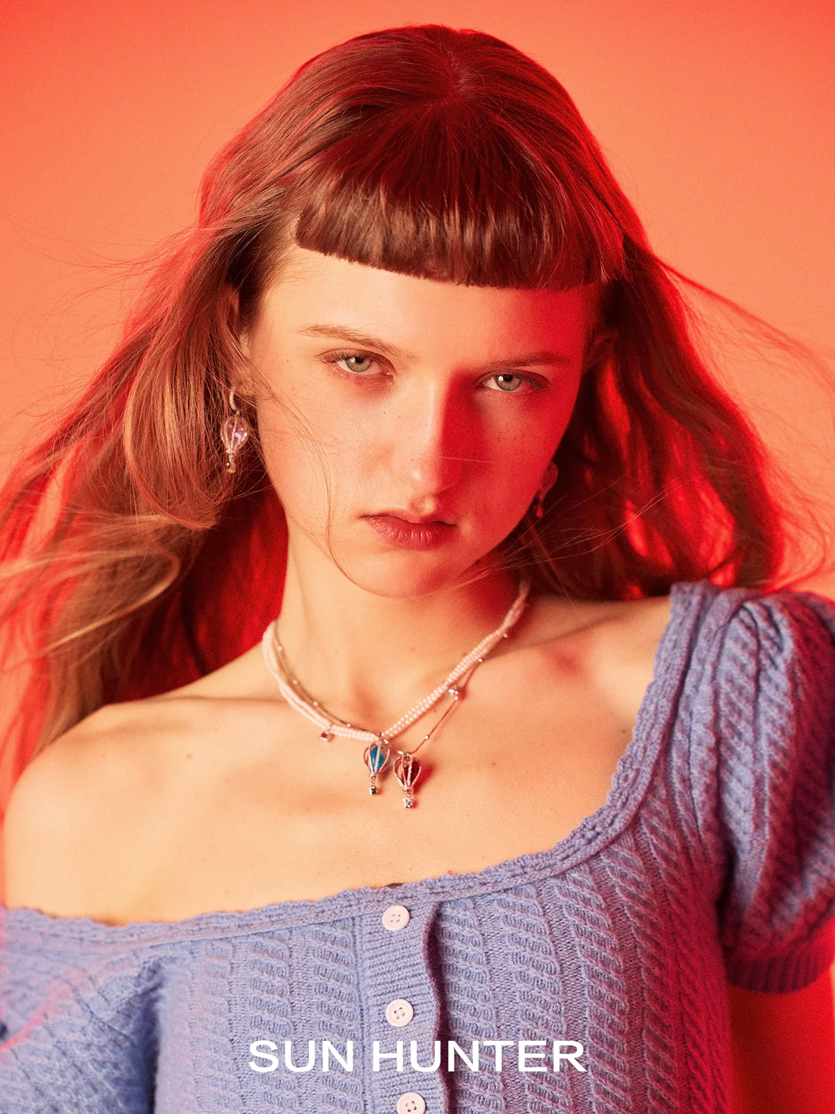 Model wearing Sun Hunter Jewelry colorful balloon zircon necklace for women with a vibrant background