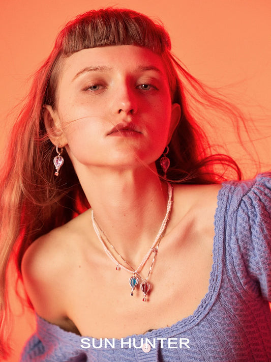 Model wearing Sun Hunter Jewelry colorful balloon zircon necklace for women paired with earrings
