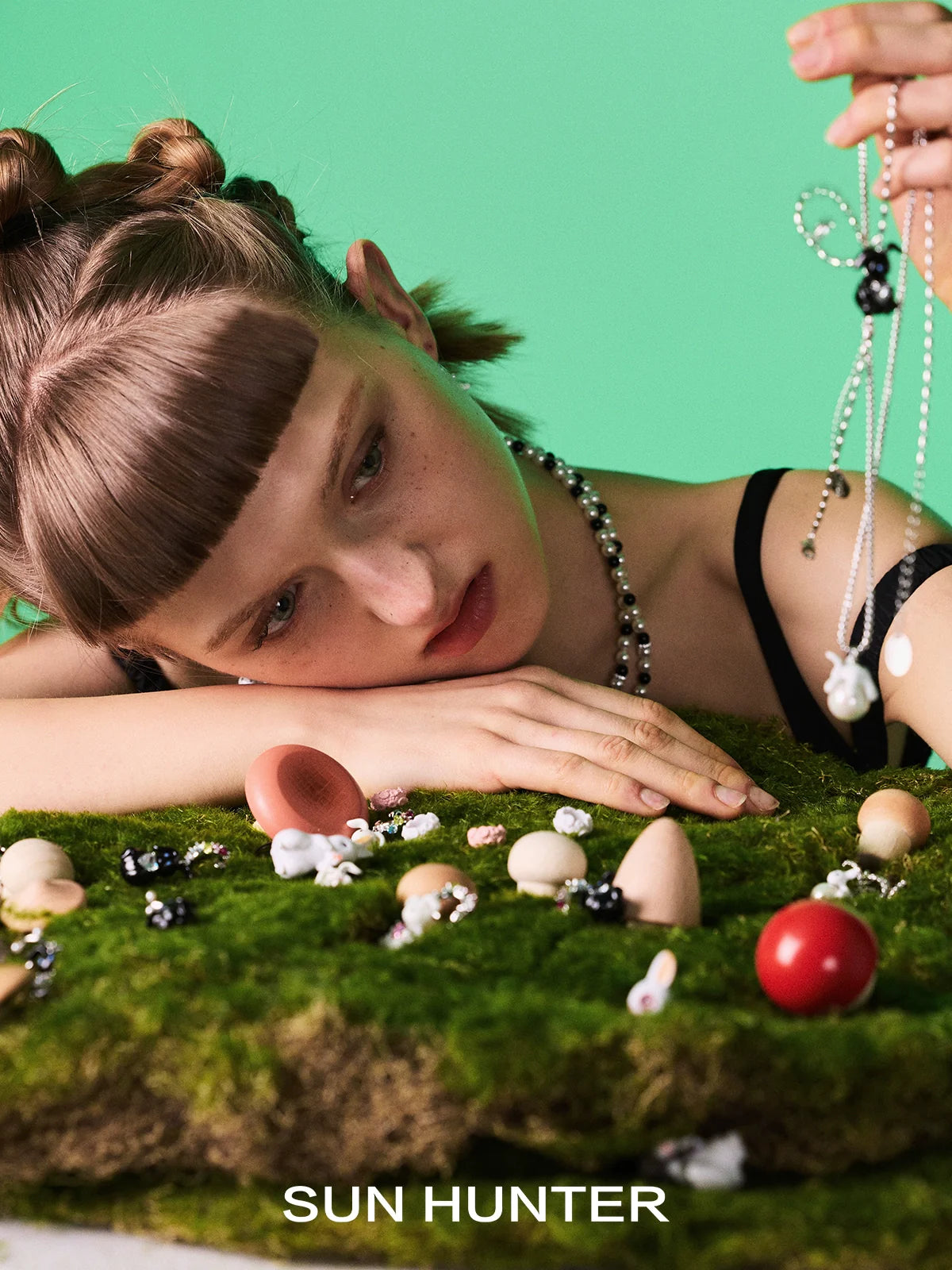 Model showcasing Sun Hunter jewelry cute rabbit necklace for women among a creative display of accessories