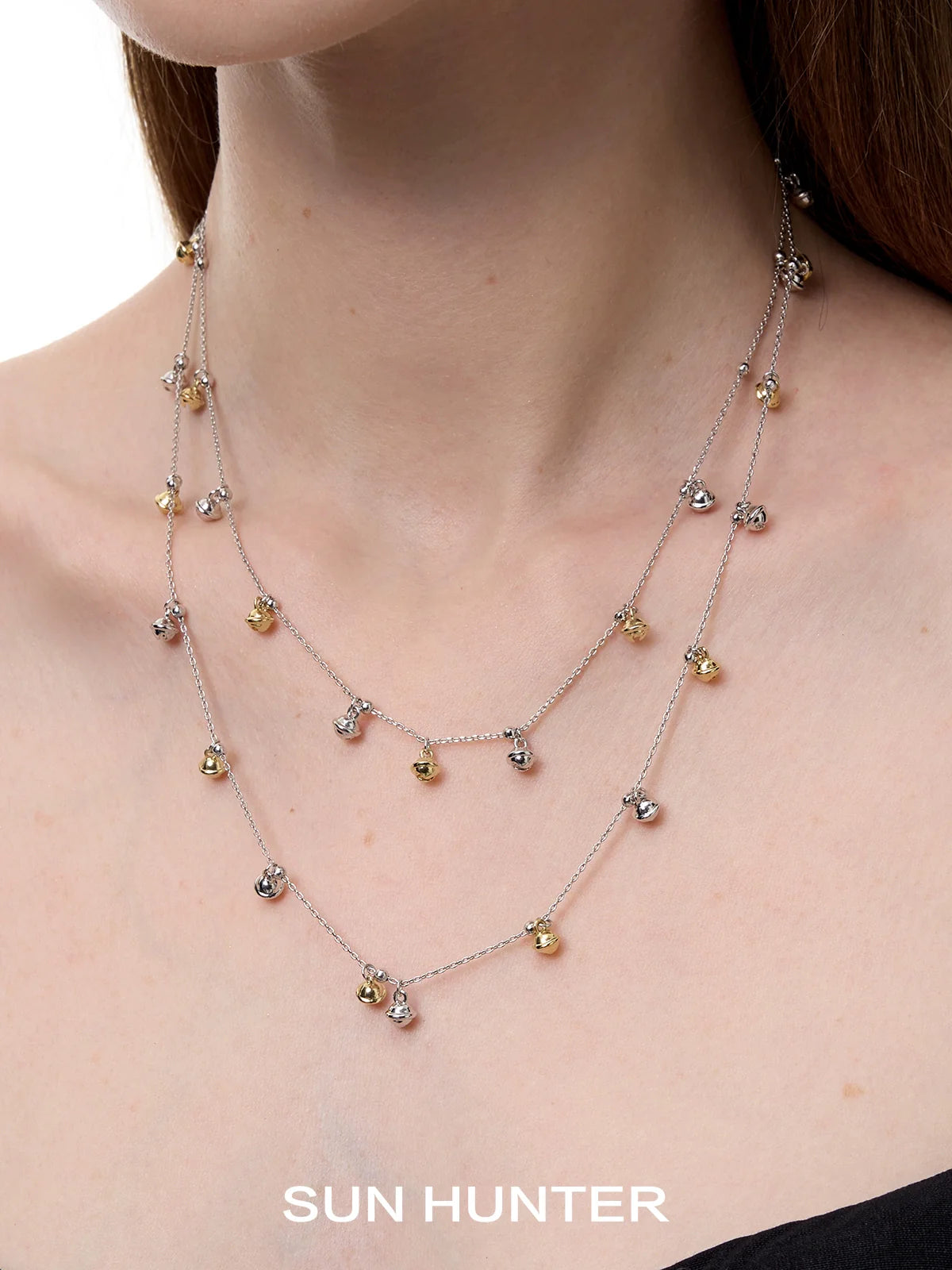 Elegant SUN HUNTER jewelry golden bell pendant necklace for women with layered design and shimmering details