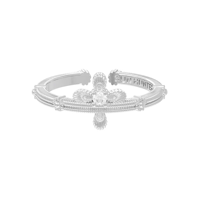 SUN HUNTER lace cross ring in silver with intricate design and sparkling gemstone centerpiece