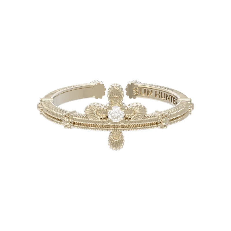 Elegant SUN HUNTER lace cross ring featuring intricate detailing and a sparkling center stone