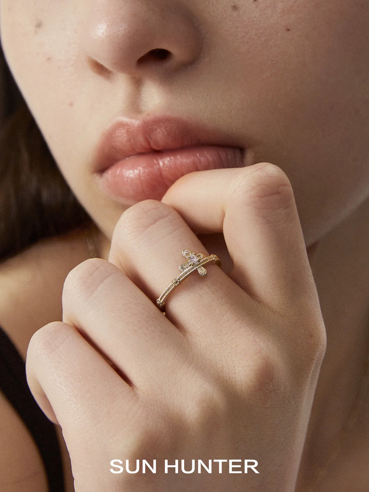 SUN HUNTER lace cross ring displayed on a model's hand with elegant styling for a chic look