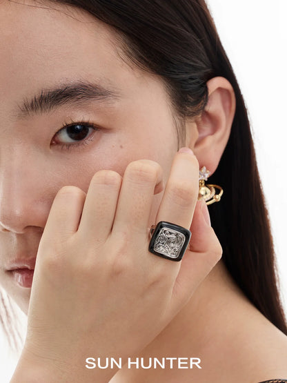 Close-up of a model wearing a SUN HUNTER retro coin ring with intricate detailing