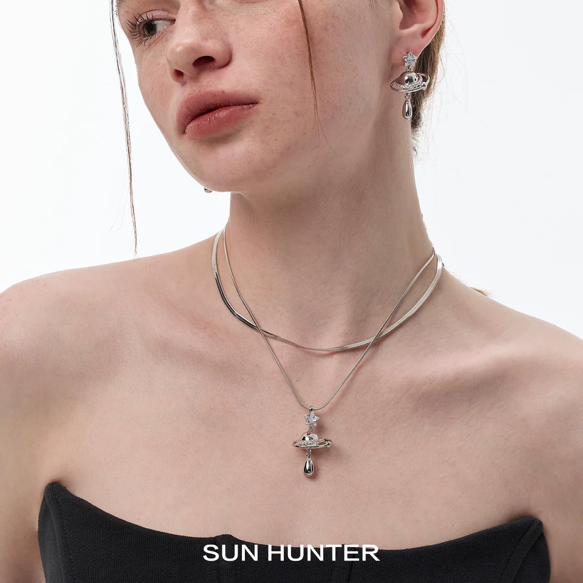 SUN HUNTER universe planet silver necklace with a planet design and shimmering accents