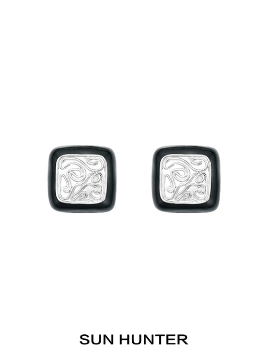 Elegant vintage coin stud earrings by SUN HUNTER with intricate silver designs and a classic look
