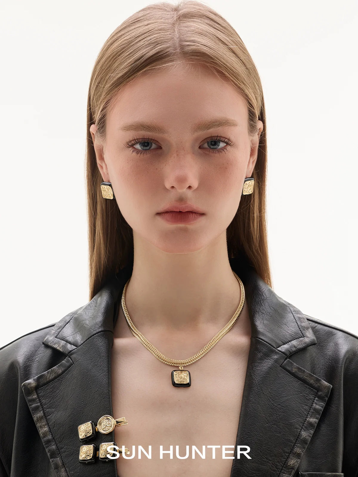 Model wearing SUN HUNTER vintage coin stud earrings with gold chains for a chic look