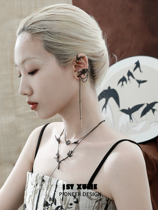 Stylish swallow ear clips with intricate design, worn by a model for a chic look