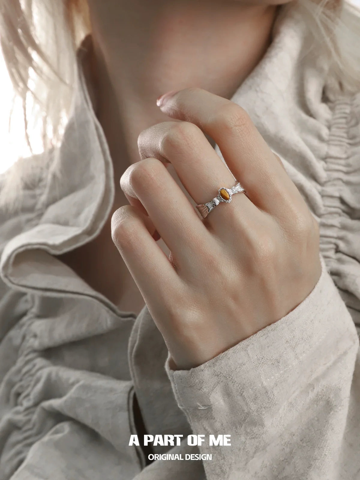 Elegant tiger eye ring for women set in a delicate silver band, worn on a hand with stylish attire