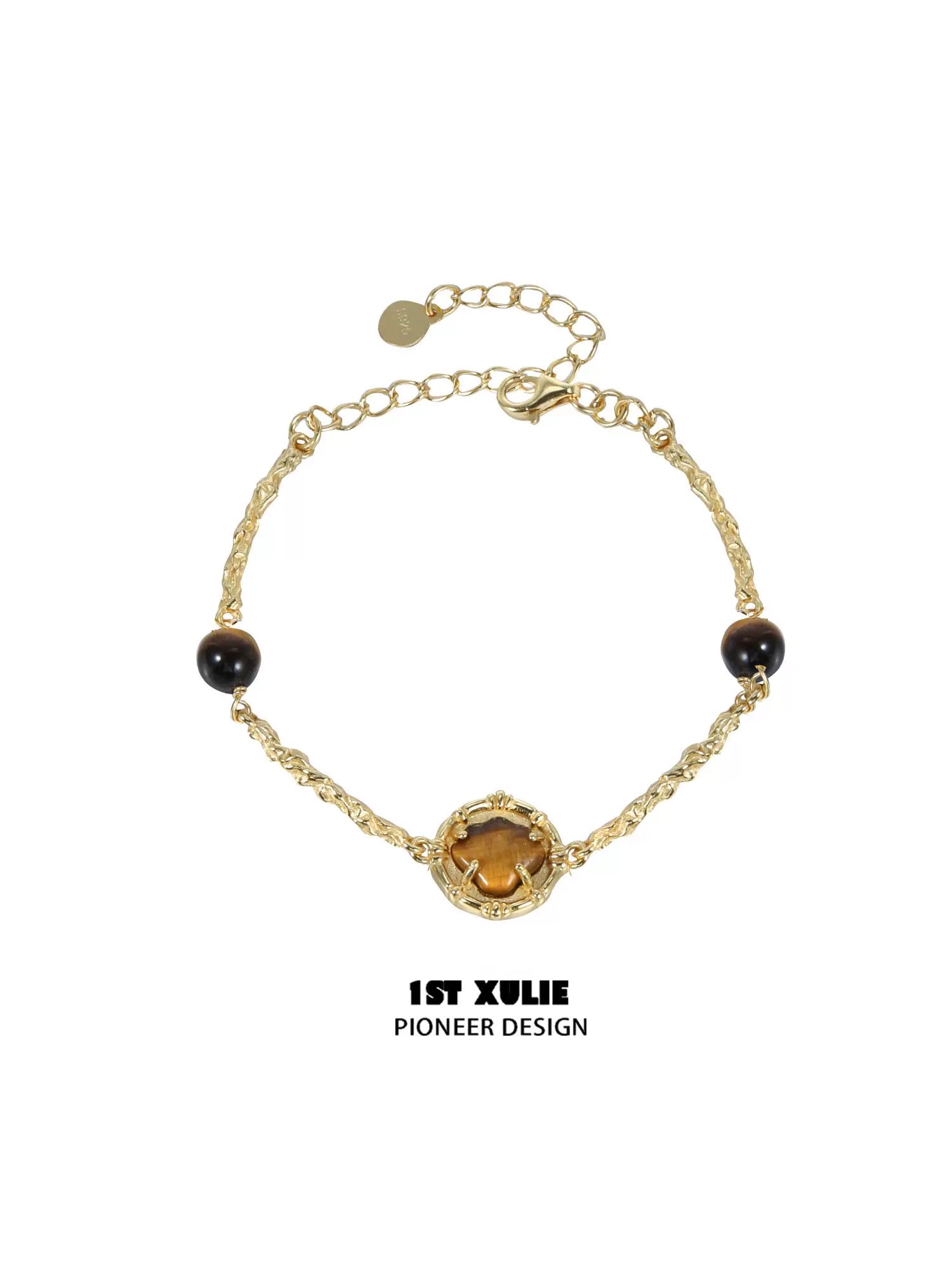 Elegant tiger eye shell silver bracelet with gold accents and adjustable chain closure