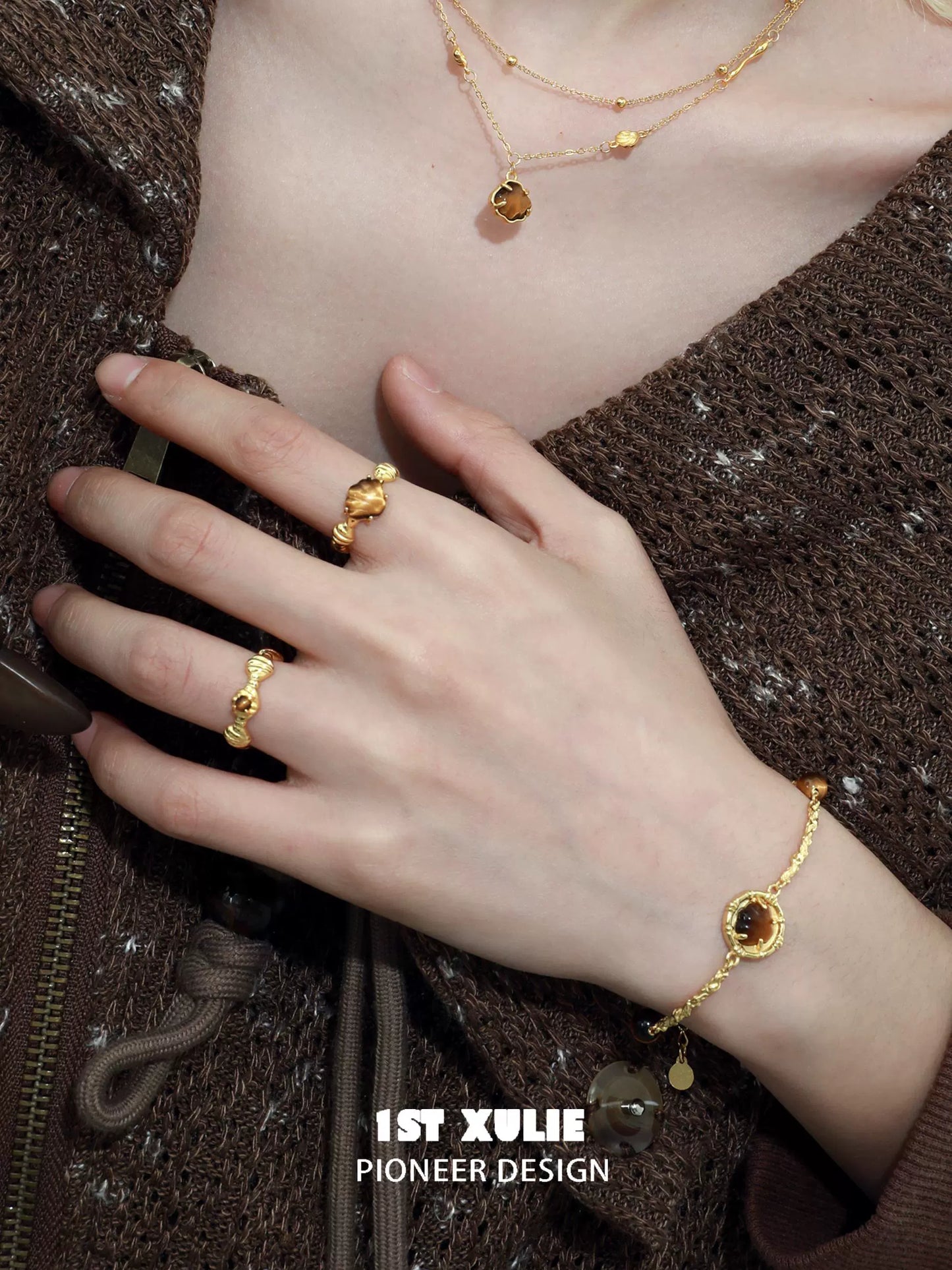 Elegant tiger eye shell silver bracelet displayed on a hand with coordinating gold jewelry