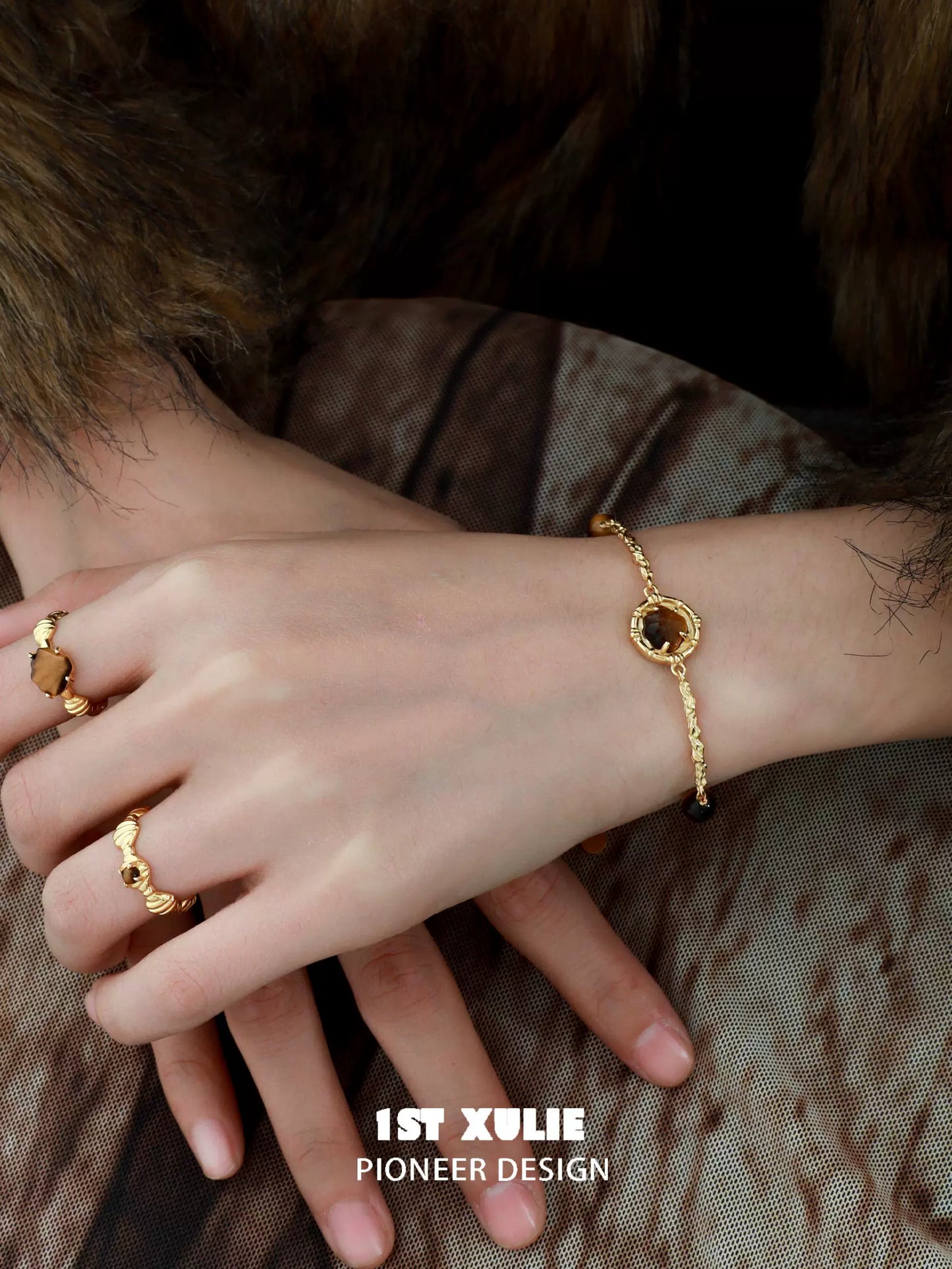 Elegant tiger eye shell silver bracelet designed by 1STXULIE, worn on a model's wrist