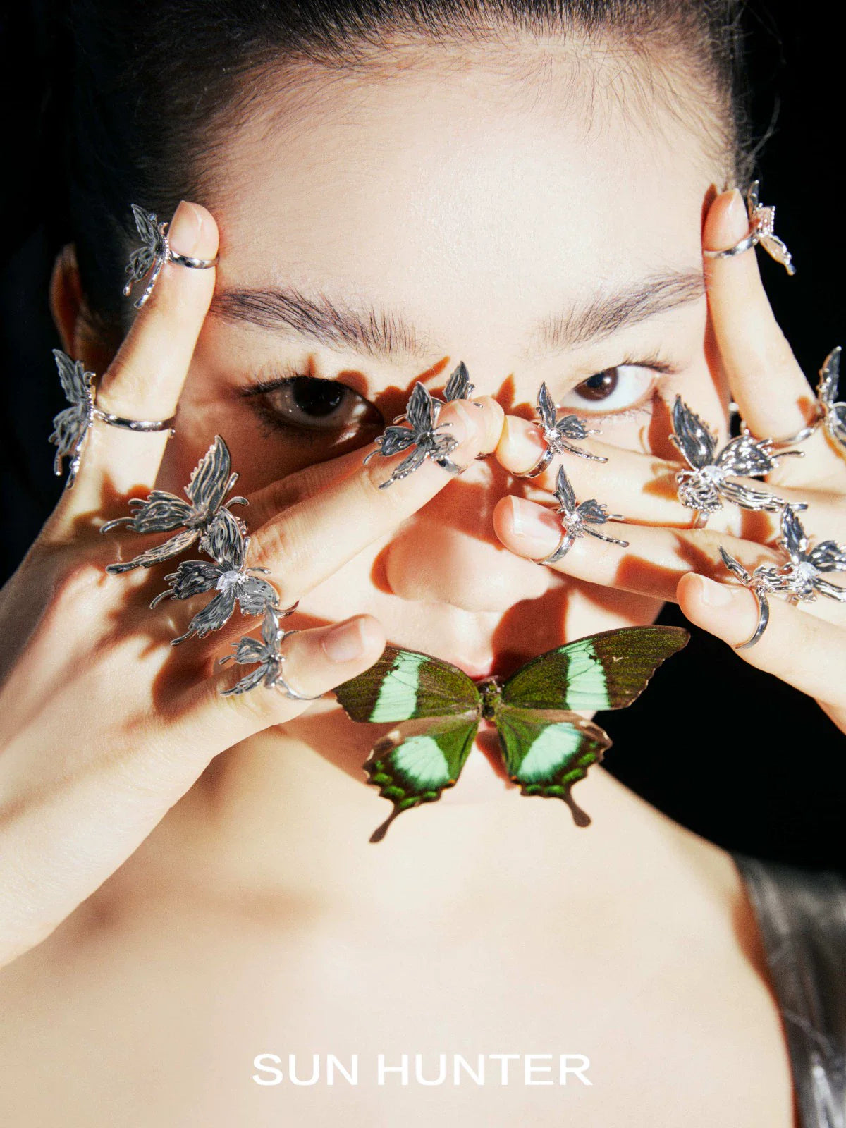 Elegant SUN HUNTER transparent butterfly earrings showcasing intricate design and delicate craftsmanship