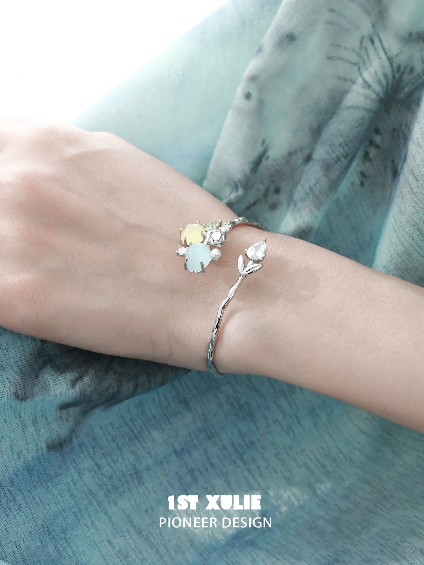 Elegant tulip silver bracelet featuring delicate floral charms and a sleek design by 1ST XULIE