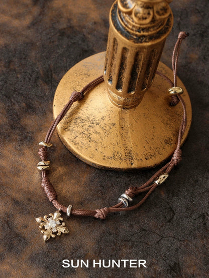 Twilight Iris braided bracelet featuring a decorative charm and adjustable design by SUN HUNTER