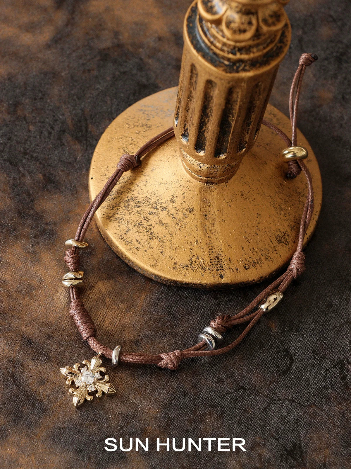 Twilight Iris braided bracelet by SUN HUNTER featuring a decorative charm and adjustable closure