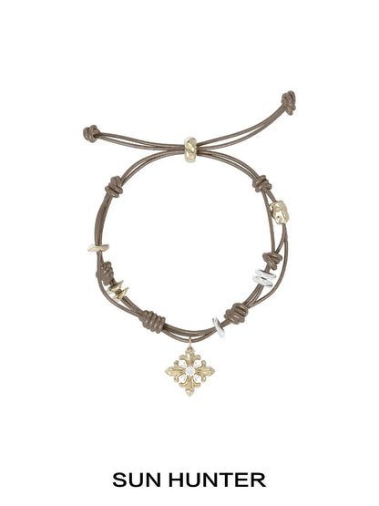 SUN HUNTER Twilight Iris braided bracelet with decorative charms and adjustable closure