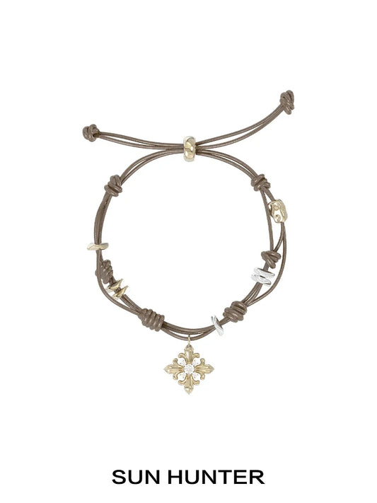 SUN HUNTER Twilight Iris braided bracelet with decorative charms and adjustable closure