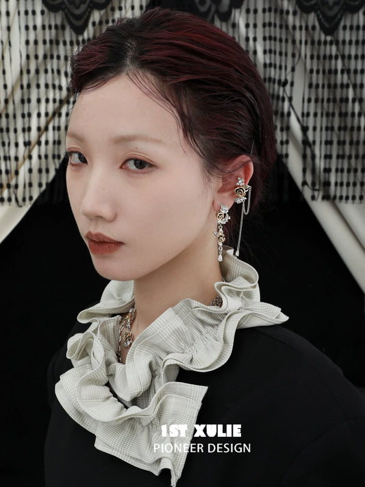 Stylish twilight rose punk earrings showcased on a model with a ruffled collar