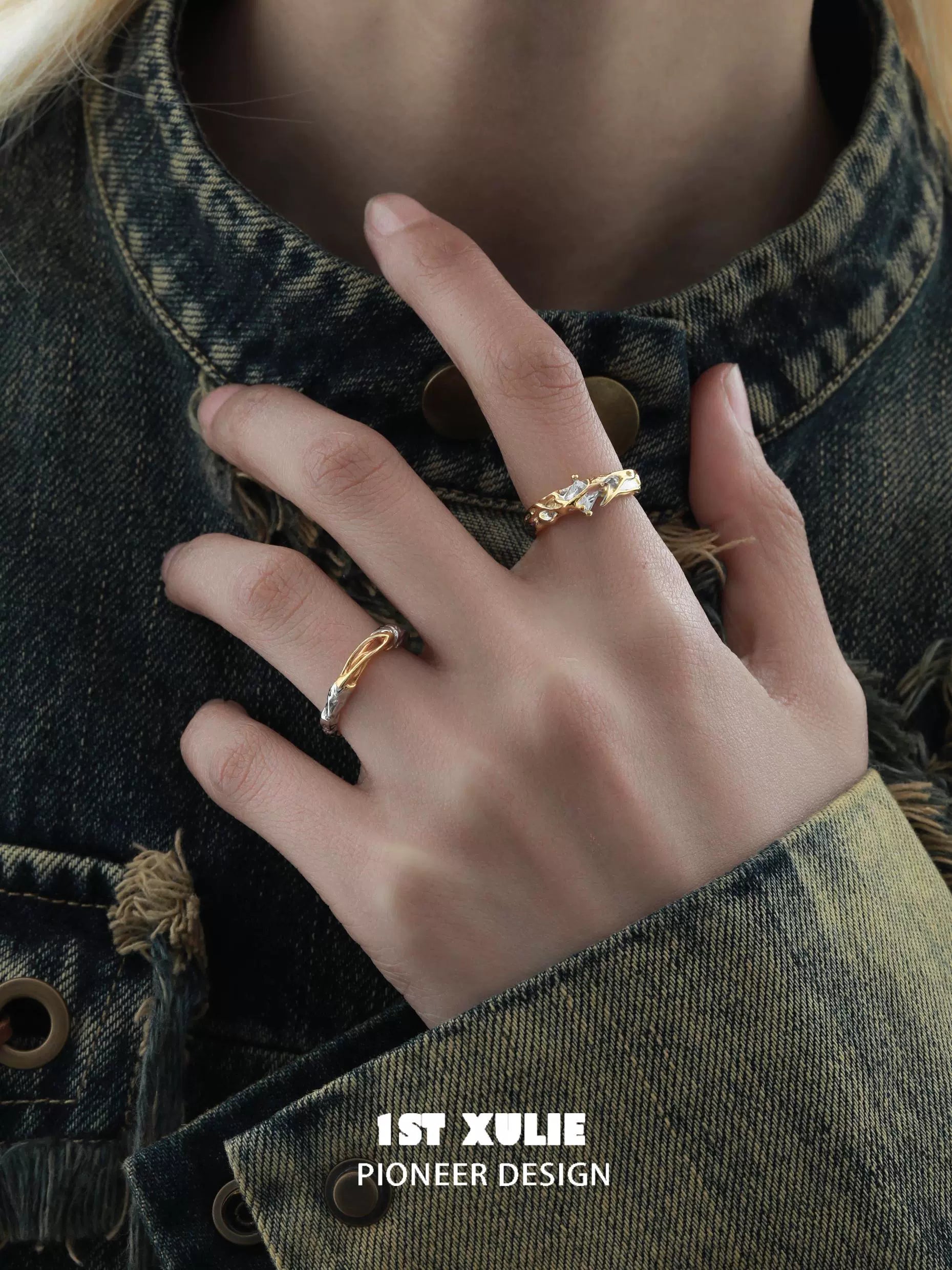 Elegant hand model displaying unique couple rings in gold with intricate designs