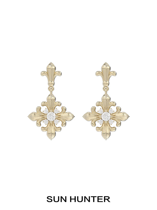 Unique floral drop earrings by SUN HUNTER featuring an elegant gold design with a sparkling center stone