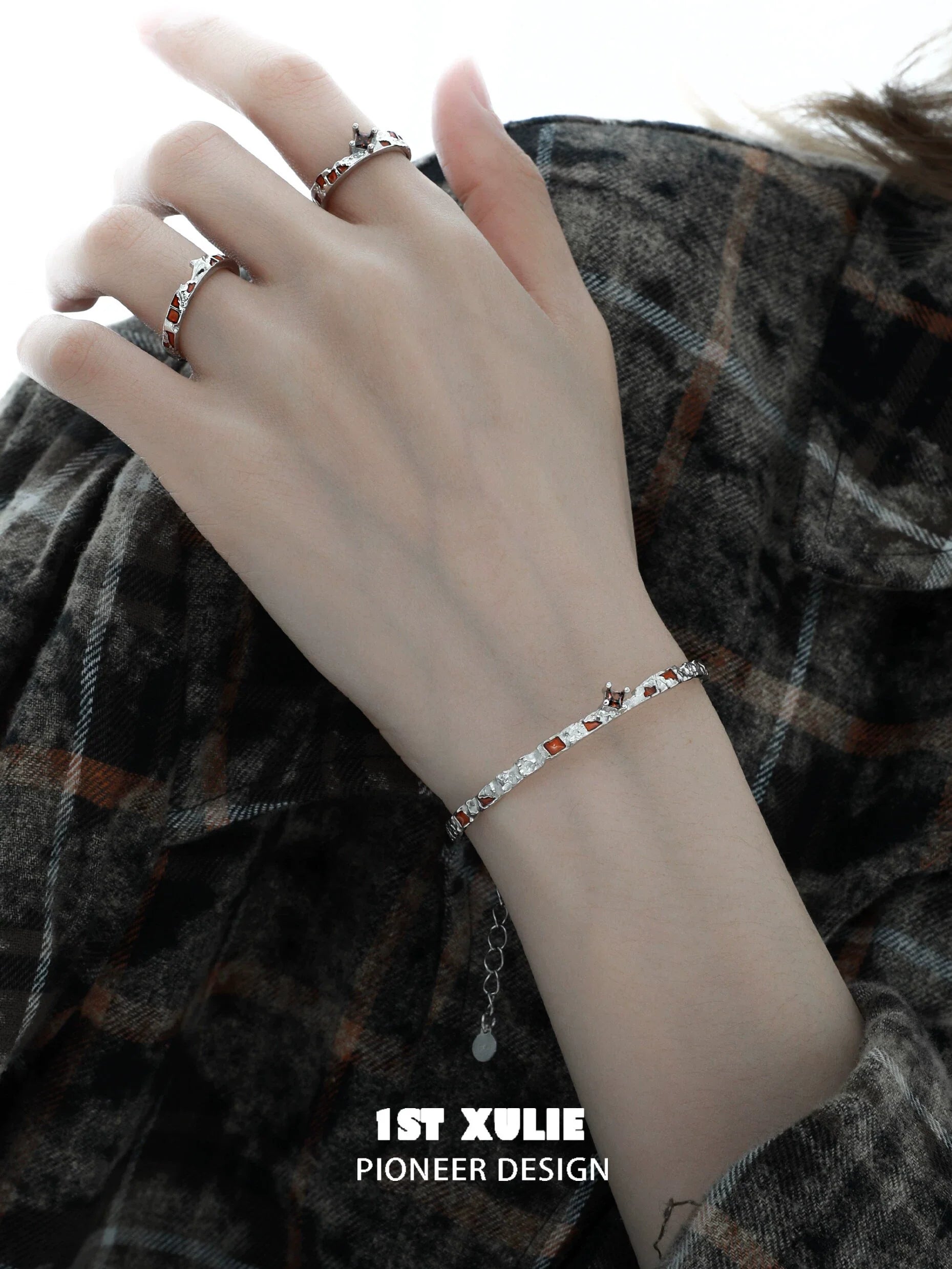 Elegant unique silver bracelet for women showcased on a hand with stylish rings, perfect for any occasion