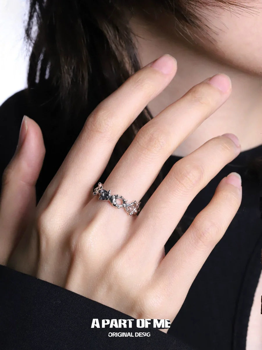 Close-up of a hand wearing a unique silver ring from A PART OF ME showcasing intricate design and elegance